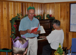 Geoff Hinde and Jeanette Barklamb lead Carols at the Christmas Dinner